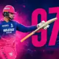 Young Indian IPL batter playing an explosive six-hitting innings during a high-pressure night cricket match in a packed stadium.