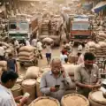 Busy Indian wholesale commodity market with traders, agricultural goods, and supply chain activity reflecting rising commodity and inflation trends representative image.