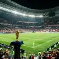 Modern football stadium with a championship trophy representing the FIFA World Cup 2026 tournament.