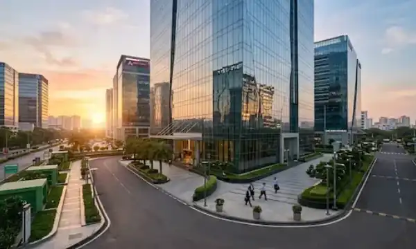 A sleek widescreen view of a modern, multi-story glass commercial tech park building in Navi Mumbai during early morning business hours representative image.