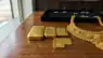 Close-up of gold bars and coins on a financial newspaper.