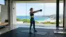 A person performing a kettlebell swing in a sunlit modern home gym. Representative Image