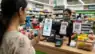 A realistic image showing a person paying via RBI Digital Rupee at a retail store in India. Representative Image