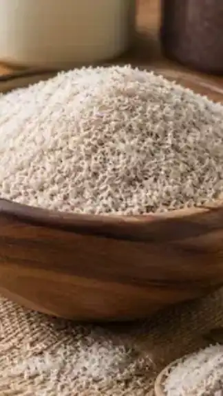 Natural psyllium husk (Isabgol) displayed in a wooden bowl representing dietary fiber and digestive wellness.