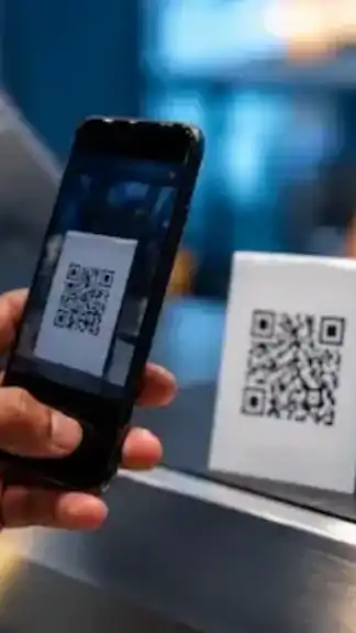 Smartphone scanning a QR code representing digital payments and online security awareness.