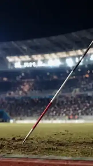 Javelin resting on the athletics field after a record-breaking throw at an international stadium.