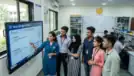 A realistic scene of young Maharashtrian students in a modern, well-lit tech lab at a state college, learning Artificial Intelligence modules on a large screen as part of the Maharashtra AI Policy 2026 – Akhand News.