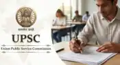 UPSC exam banner featuring the golden Indian national emblem, text, and a student writing an examination in a classroom.