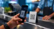 Smartphone scanning a QR code representing digital payments and online security awareness.