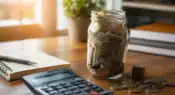 A savings jar filled with money symbolizing consistent daily saving and long-term wealth building.
