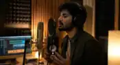 Independent musician recording music in a modern home studio environment representative image.