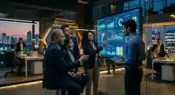 Corporate executives and engineers reviewing AI-powered business analytics inside a modern technology office.