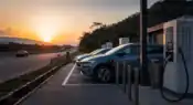 Electric vehicle charging station operating beside a modern expressway in Maharashtra during evening travel hours.