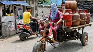 A worker carries LPG cooking gas cylinders for delivery, amid a shortage linked to the ongoing West Asia conflict (PTI)