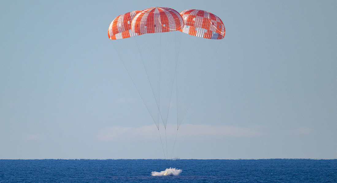 Artemis II Orion capsule floating in the Pacific Ocean with recovery teams nearby. Image Credit: @NASAArtemis/X Handle