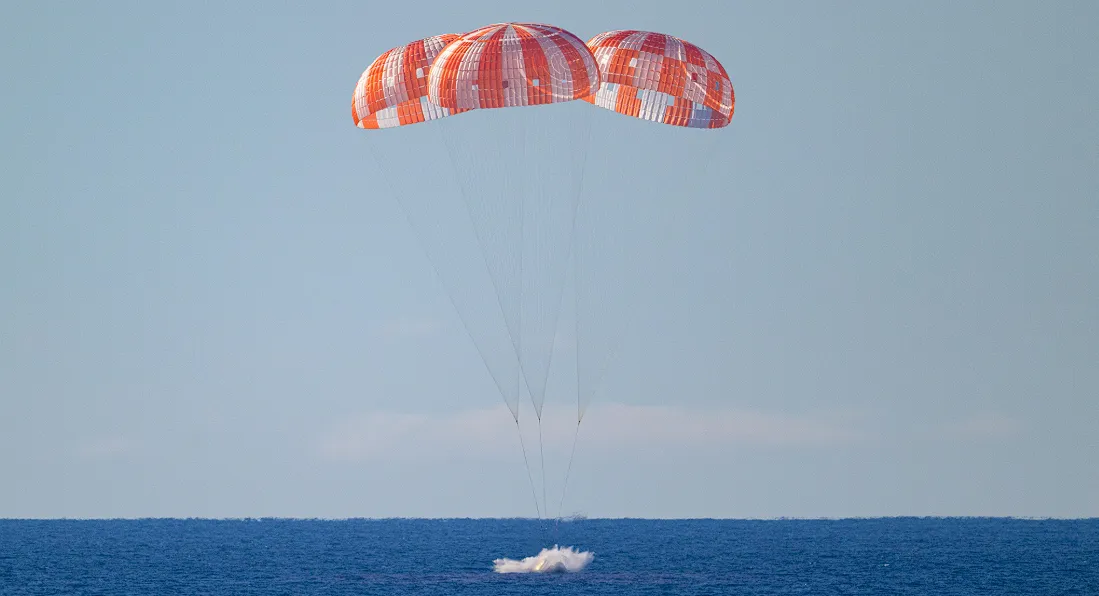 Artemis II Orion capsule floating in the Pacific Ocean with recovery teams nearby. Image Credit: @NASAArtemis/X Handle
