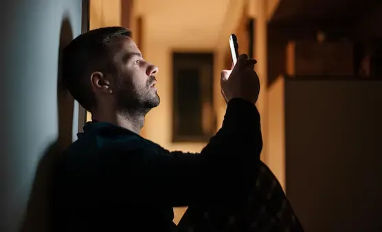 Young professional sitting alone at night reflecting on stress, loneliness, and emotional exhaustion in modern urban life.